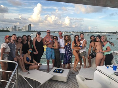 Friends celebrating on a yacht with Miami in the distance