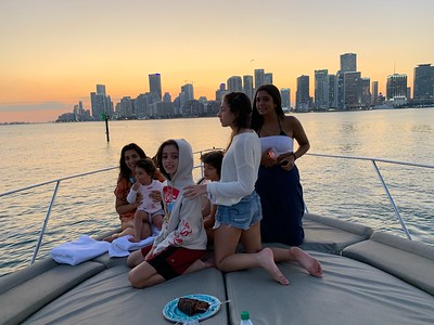 Family enjoying a sunset yacht cruise in Miami