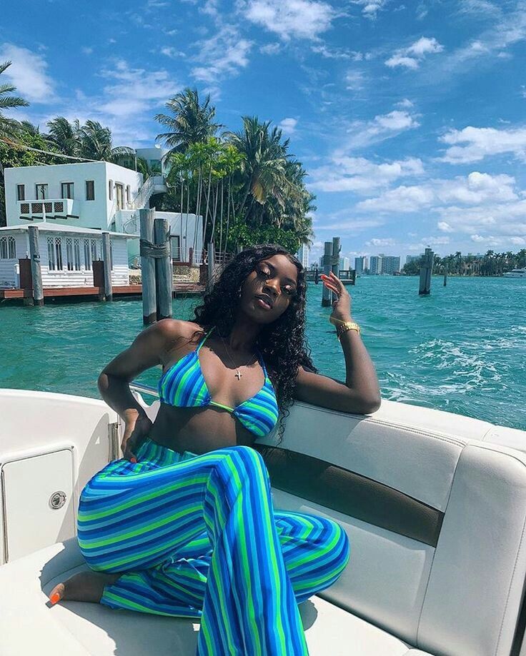 Guest relaxing on a Miami yacht with turquoise water and palm trees