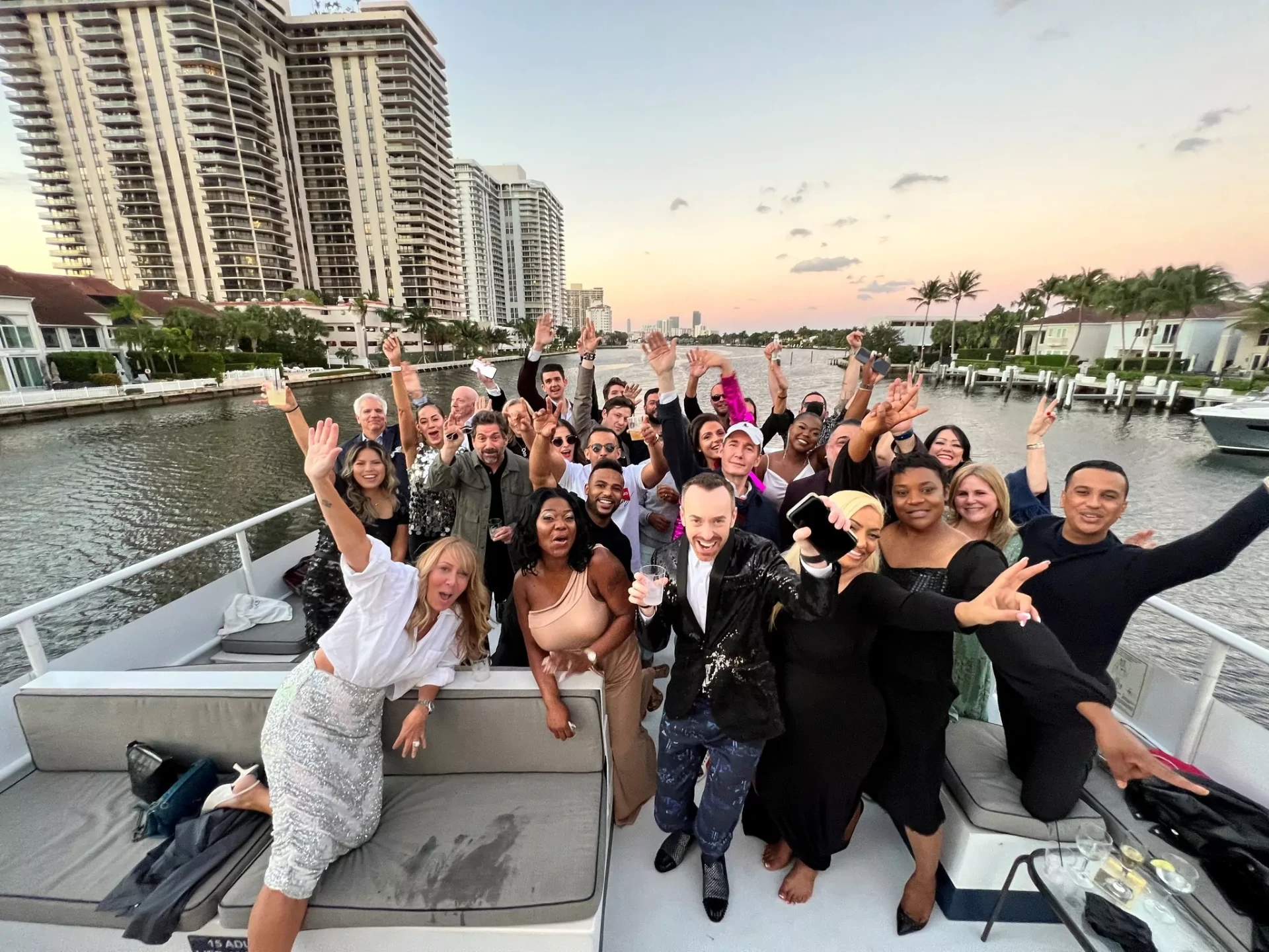 Large group celebrating on a sunset yacht dinner cruise